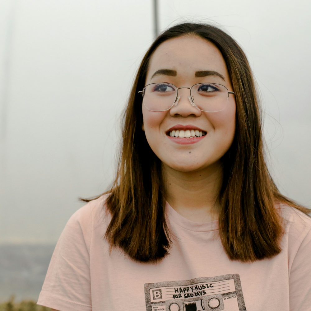 Young asian woman hopeful and smiling