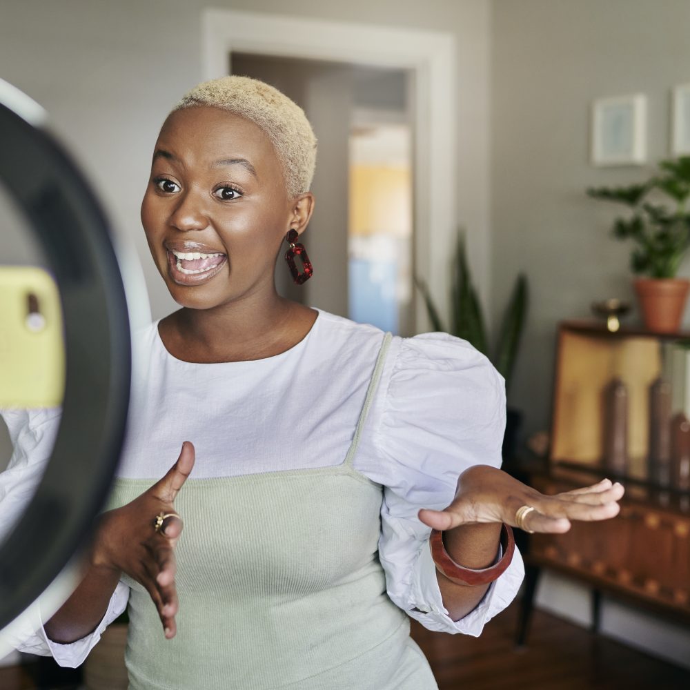 Young woman influencer in her home with an animated happy expression